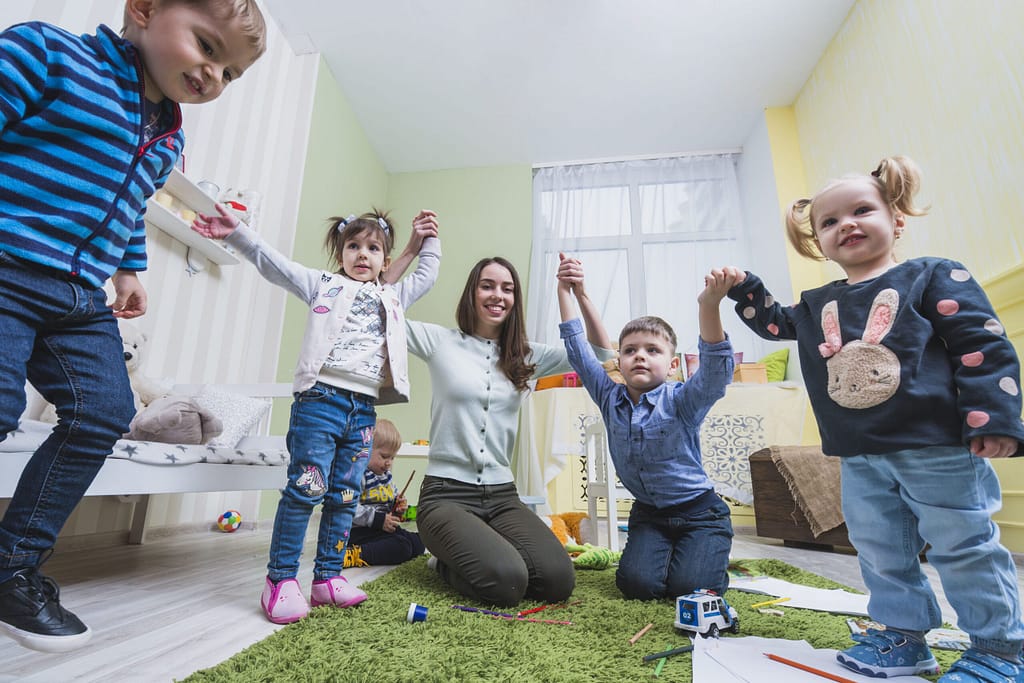 Teacher and kids playing in the classroom
