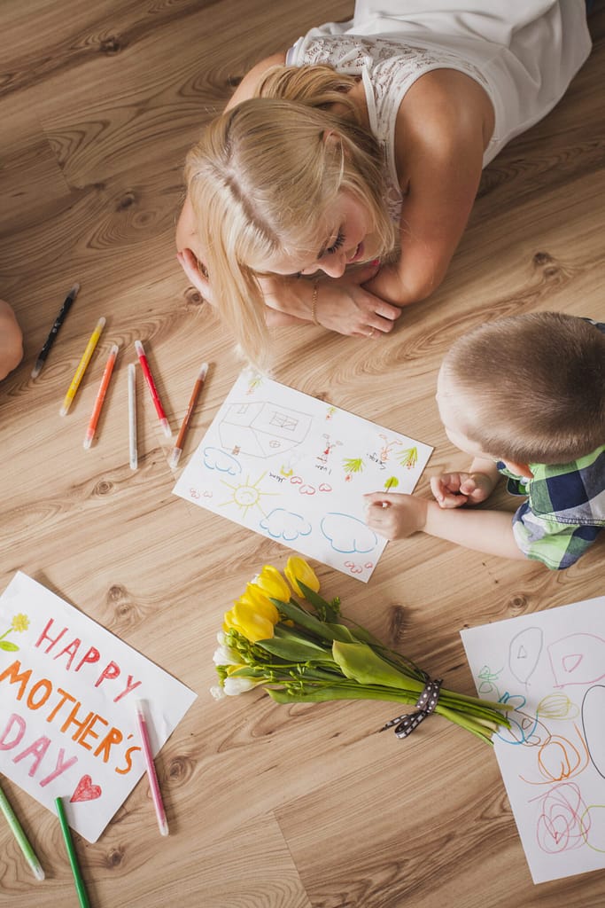 happy-woman-lying-floor-with-her-son