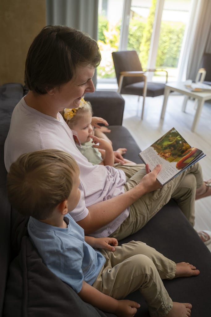 Parent reading a book to kids